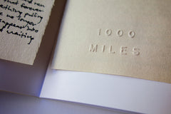Embossed 1000 Miles logo - 1000 Miles Vol. 8 Special Edition Zine by Jason Jaworski