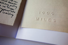 Embossed 1000 Miles logo - 1000 Miles Vol. 6 Special Edition Zine by Jason Jaworski