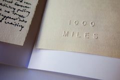 Embossed 1000 Miles logo - 1000 Miles Vol. 7 Special Edition Zine by Jason Jaworski